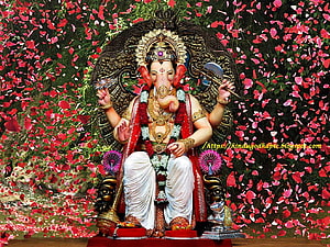 Lord Ganesha Seated on Ornate Throne Surrounded by Vibrant Rose Petals and Floral Garlands HD wallpaper