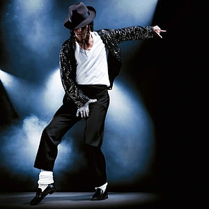 Michael Jackson performing the moonwalk in a sequined jacket and fedora on a smoky stage HD phone wallpaper