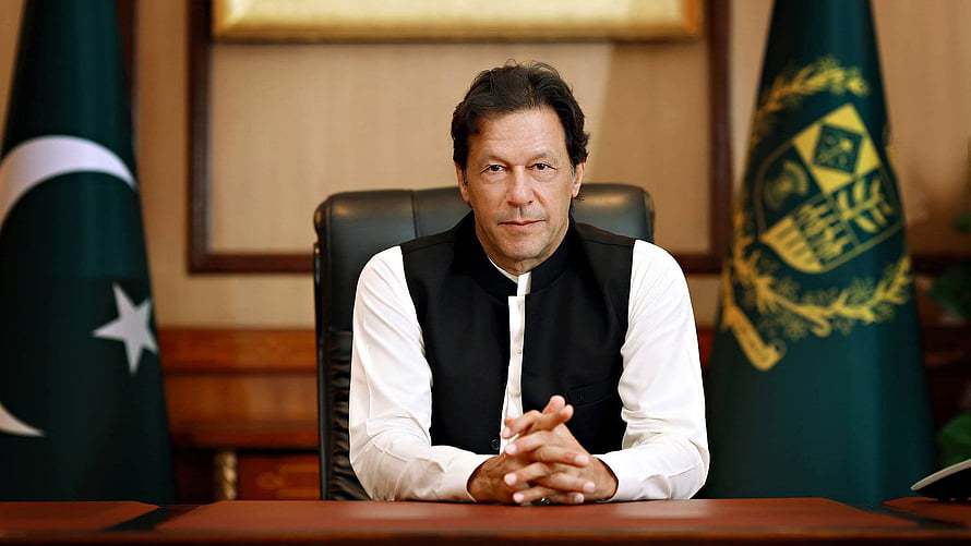 Imran Khan Sitting at Desk with Pakistan Flag and Presidential Emblem in Formal Portrait HD wallpaper