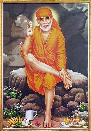 Sai Baba Sitting on Rock with Shanti Hand Gesture and Offerings HD phone wallpaper