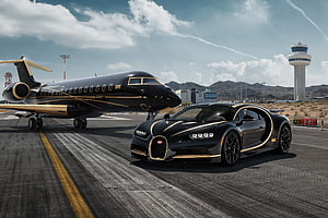 Black and Gold Bugatti Chiron and Private Jet on Airport Runway HD wallpaper