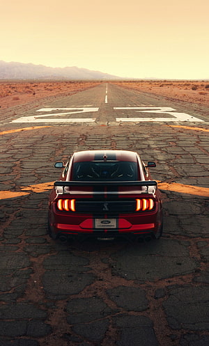 Rear View of a Red Ford Mustang Shelby GT500 on a Desert Runway at Sunset HD phone wallpaper