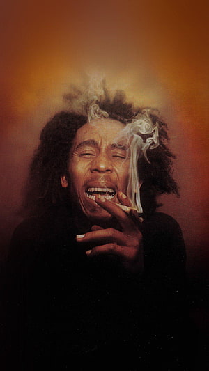 Bob Marley Portrait with Cigarette Smoke Against Warm Orange Background HD phone wallpaper
