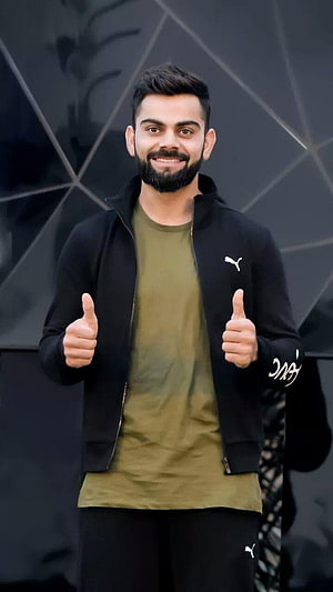 Virat Kohli Giving Double Thumbs Up In Black Puma Jacket And Olive T-Shirt HD phone wallpaper