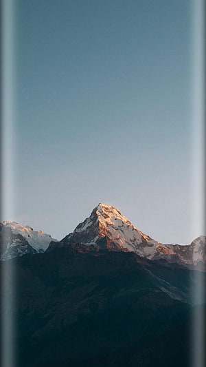 Snow-Capped Mountain Peak at Golden Hour with Clear Blue Sky HD phone wallpaper