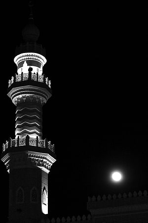 Illuminated Islamic Minaret and Full Moon in High-Contrast Black and White Night Photography HD phone wallpaper