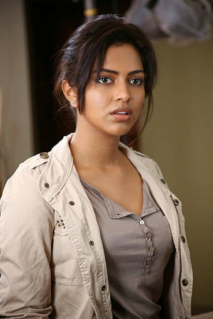 Amala Paul in a beige trench coat and grey shirt with a serious expression HD phone wallpaper