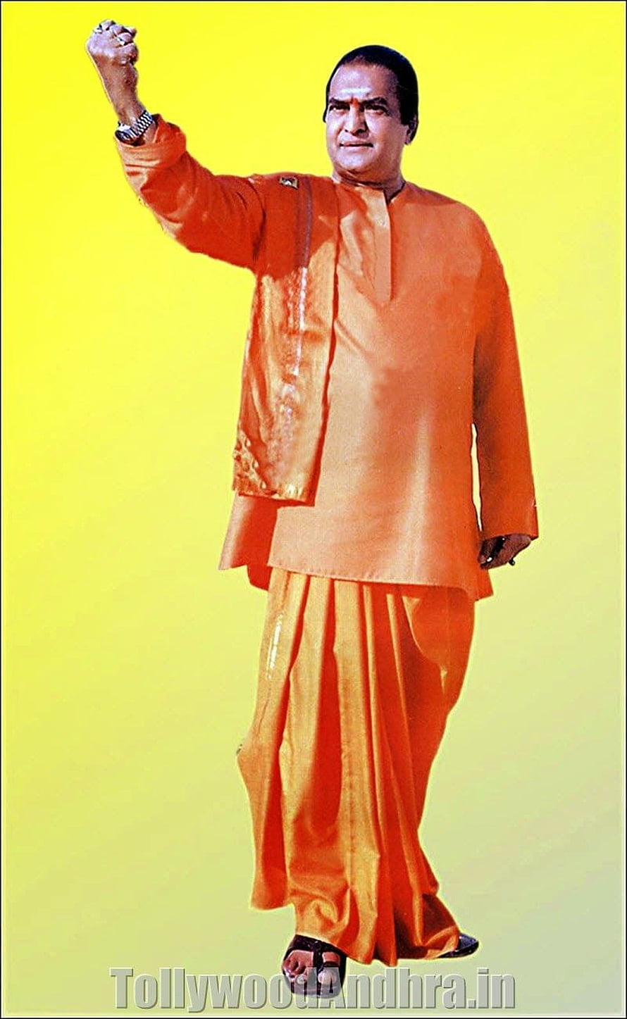 Nandamuri Balakrishna in Traditional Orange Kurta and Dhoti with Raised Fist HD phone wallpaper