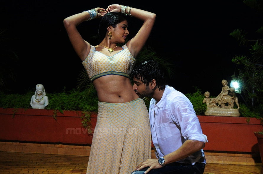 Priyamani in Traditional Attire with Male Actor in Nighttime Garden Scene HD wallpaper