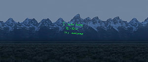 Snowy Mountain Range at Dusk with Green Text Overlay HD wallpaper