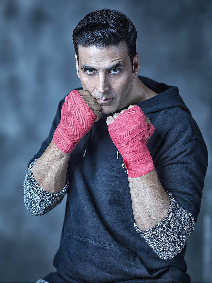 Akshay Kumar in a boxing stance with red hand wraps and a black hoodie HD phone wallpaper