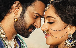 Prabhas and Anushka Shetty in traditional Indian attire with ornate jewelry and nose ring HD wallpaper