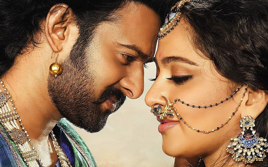 Prabhas and Anushka Shetty in traditional Indian attire with ornate jewelry and nose ring HD wallpaper