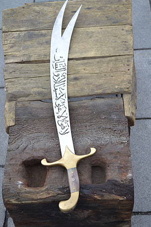 Ornate Tulwar Sword with Arabic Calligraphy on Blade and Brass Hilt HD phone wallpaper