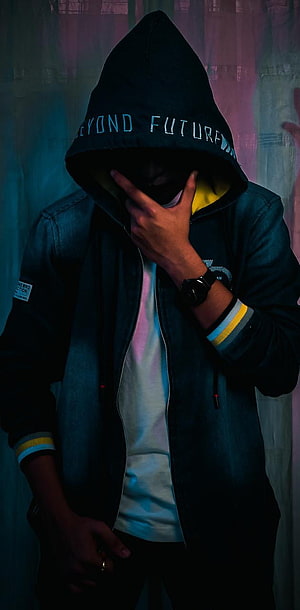 Mysterious Hooded Figure in Dark Streetwear with Neon Lighting HD phone wallpaper