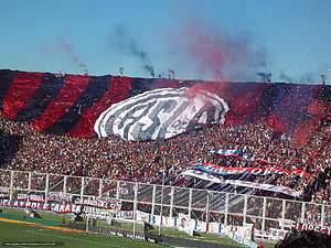 San Lorenzo de Almagro stadium tifo with red smoke and massive crowd HD wallpaper