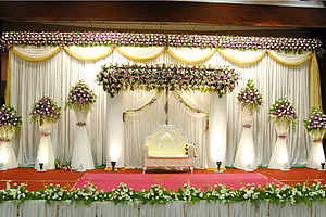 Elegant Indian Wedding Stage Decor with Floral Arrangements and Traditional Sofa HD wallpaper