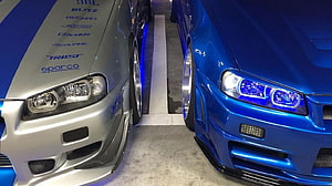Silver and Blue Nissan GT-R R34 Tuned Cars Side by Side in Garage HD wallpaper