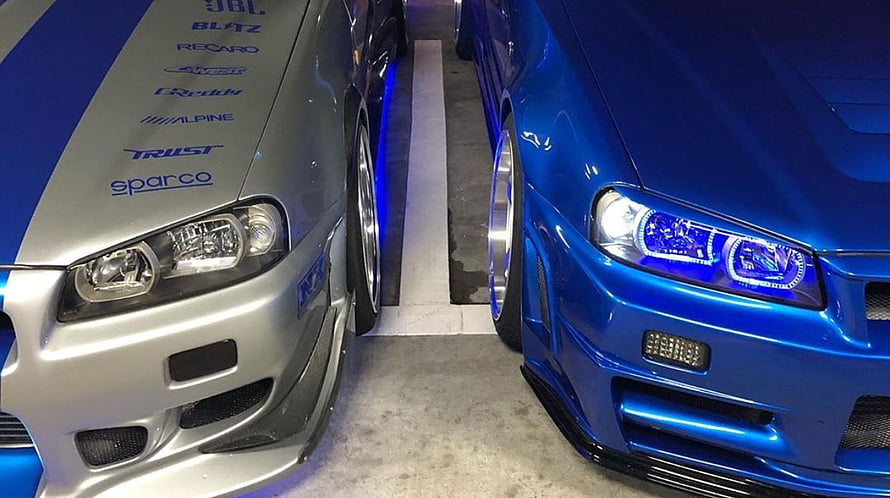 Silver and Blue Nissan GT-R R34 Tuned Cars Side by Side in Garage HD wallpaper