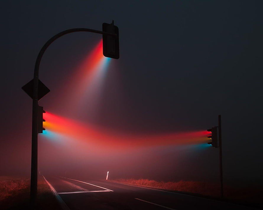 Misty Road at Night with Glowing Traffic Lights and Foggy Atmosphere HD wallpaper