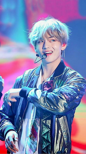 V from BTS performing on stage in a shiny bomber jacket with blue hair HD phone wallpaper