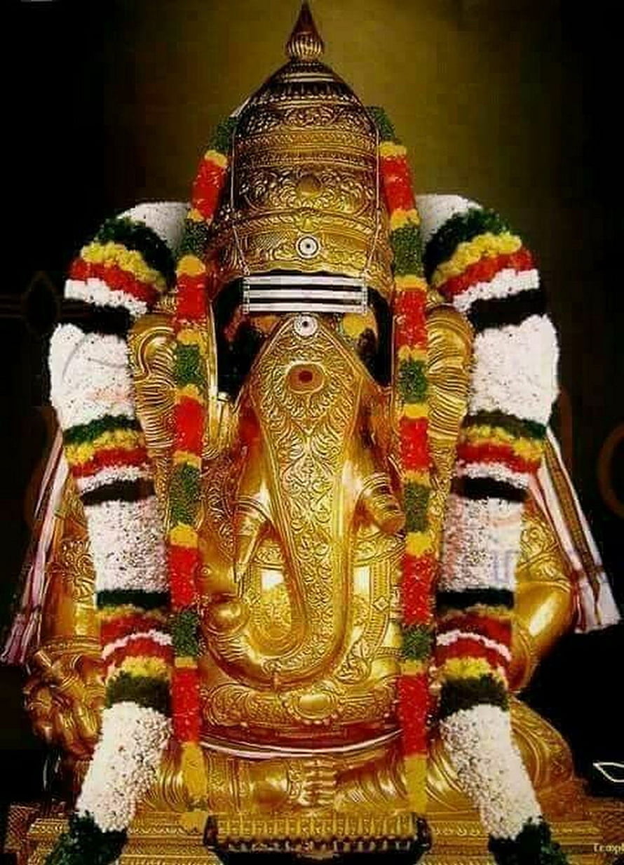 Golden Lord Ganesha Statue Adorned with Colorful Flower Garlands and Traditional Crown HD phone wallpaper