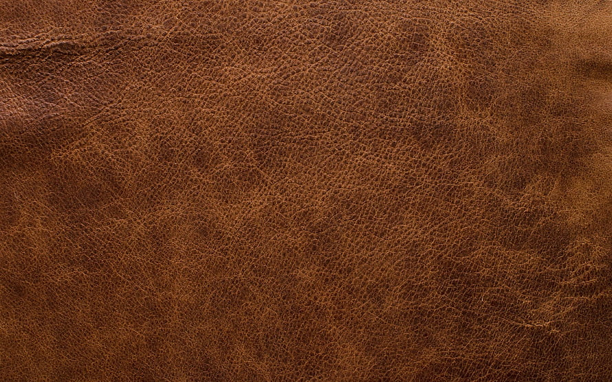 Close-Up Texture of Rich Brown Leather Surface with Natural Grain Patterns HD wallpaper