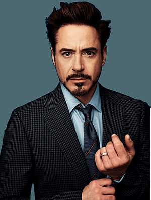 Tony Stark in a dark checkered suit with a light blue shirt and striped tie against a teal background HD phone wallpaper