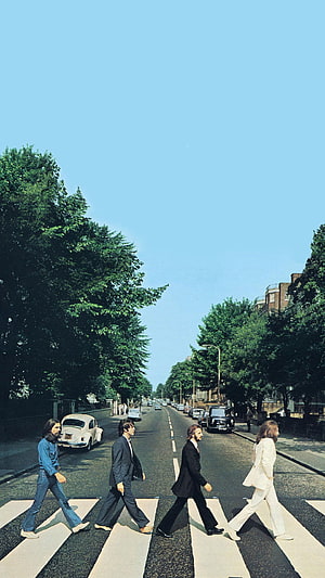 The Beatles crossing Abbey Road zebra crossing in iconic album cover photo HD phone wallpaper