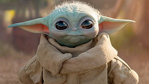 Grogu from The Mandalorian in a beige robe with large expressive eyes and pointed ears HD wallpaper