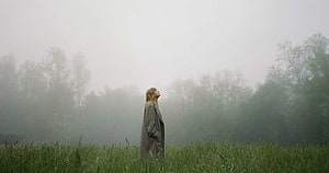 Woman in plaid coat standing in a foggy green field looking up at the misty sky, Pin on Folklore, taylor swift albums HD wallpaper