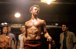 Brad Pitt as Tyler Durden in Fight Club, shirtless and intense in a dimly lit underground setting HD wallpaper