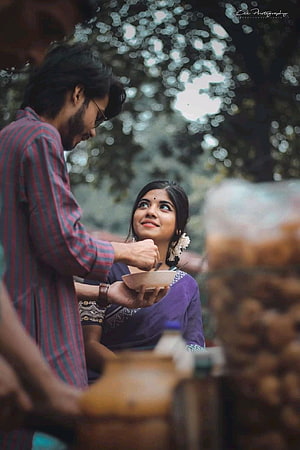 Bengali Couple Sharing a Warm Moment Over a Bowl in a Lush Garden Setting HD phone wallpaper