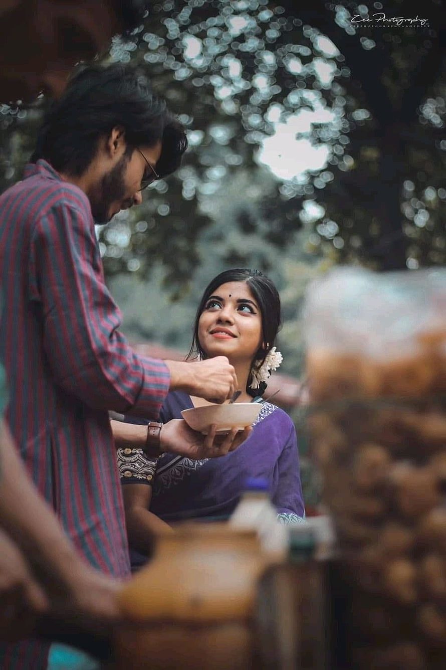 Bengali Couple Sharing a Warm Moment Over a Bowl in a Lush Garden Setting HD phone wallpaper