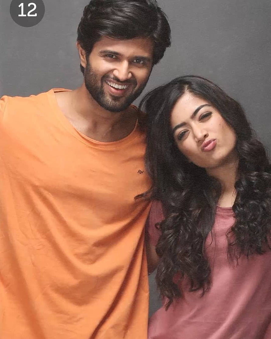 Vijay Deverakonda and Rashmika Mandanna in a playful studio portrait HD phone wallpaper