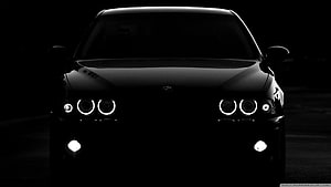 Black BMW M3 Front View With Angel Eyes Headlights In Dark Night Setting HD wallpaper