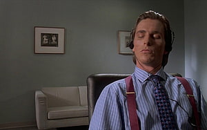 Patrick Bateman in a striped shirt and suspenders with headphones in a minimalist office, patrick bateman HD wallpaper