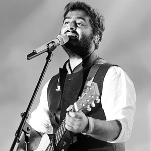 Arijit Singh performing live with acoustic guitar in black and white HD phone wallpaper