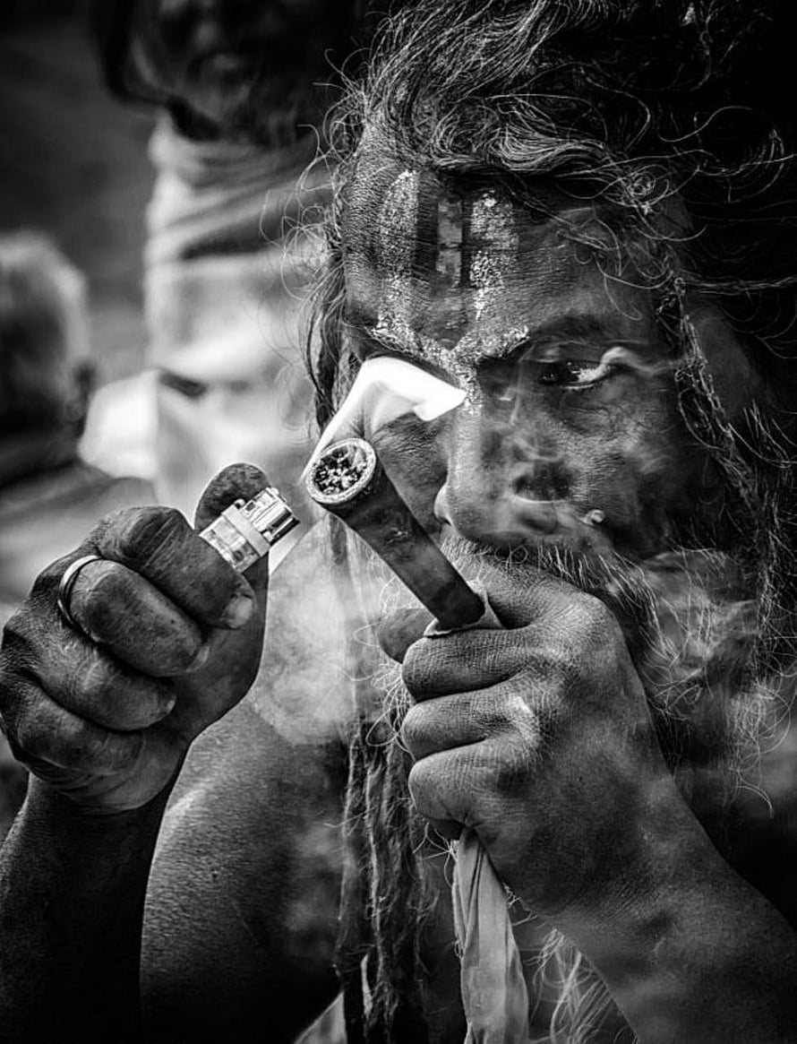 Black and white portrait of an Aghori sadhu lighting a hookah with a lighter HD phone wallpaper