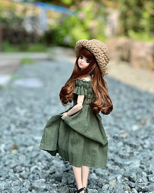 Ball Jointed Doll in Green Dress and Crochet Hat on Gravel Path HD phone wallpaper