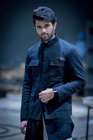 Vijay Devarakonda in a dark mandarin collar jacket with a serious expression HD phone wallpaper