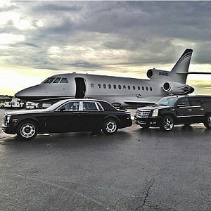 Black Rolls-Royce and Cadillac SUV Parked in Front of Private Jet on Tarmac HD phone wallpaper