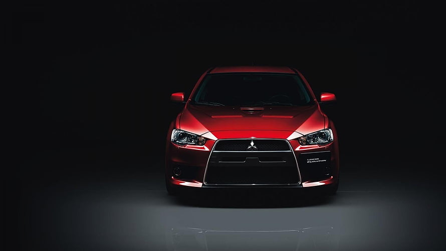 Mitsubishi Lancer Evolution X Front View in Red on Black Studio Background HD wallpaper
