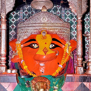Vibrant Hindu Deity Murti with Traditional Crown and Marigold Garland in Temple Setting HD phone wallpaper