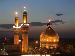 Ibrahim ibn Ali Shrine in Karbala with Golden Dome and Minarets at Dusk HD wallpaper