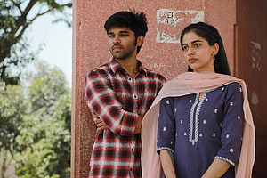 Adithya Varma and female co-star in casual outdoor portrait HD wallpaper