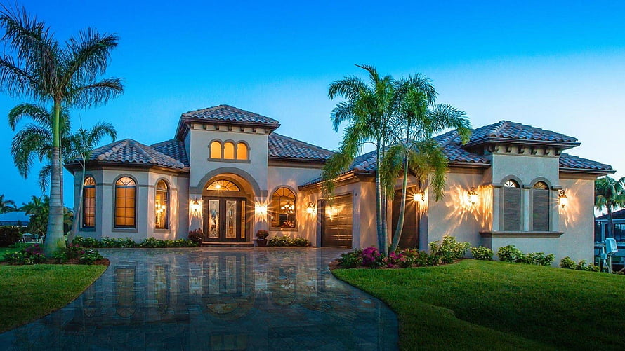 Florida Luxury Mediterranean Mansion at Dusk with Palm Trees and Wet Driveway HD wallpaper