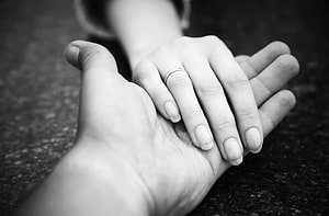 Black and white close-up of two hands holding with an engagement ring on the finger HD wallpaper
