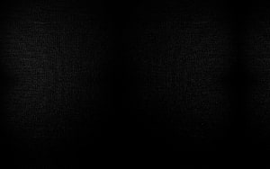Minimalist Dark Fabric Texture with Subtle Vignette and Deep Black Tones HD wallpaper