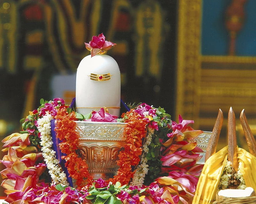Decorated Shiva Lingam with Flower Garlands and Sacred Offerings HD wallpaper